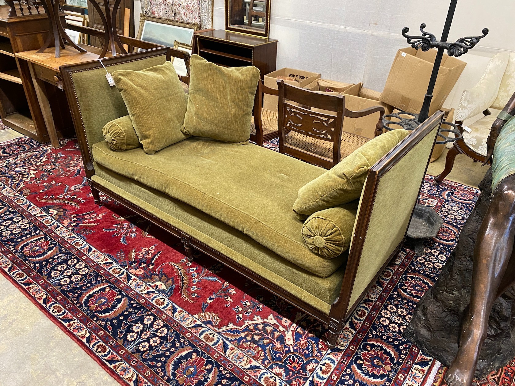 An early 20th century French upholstered mahogany day bed, length 184cm, depth 76cm, height 90cm